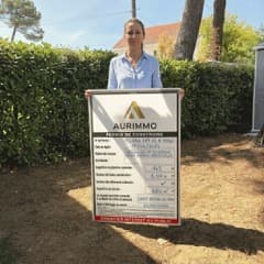 Céline avec son panneau de permis de construire Aurimmo